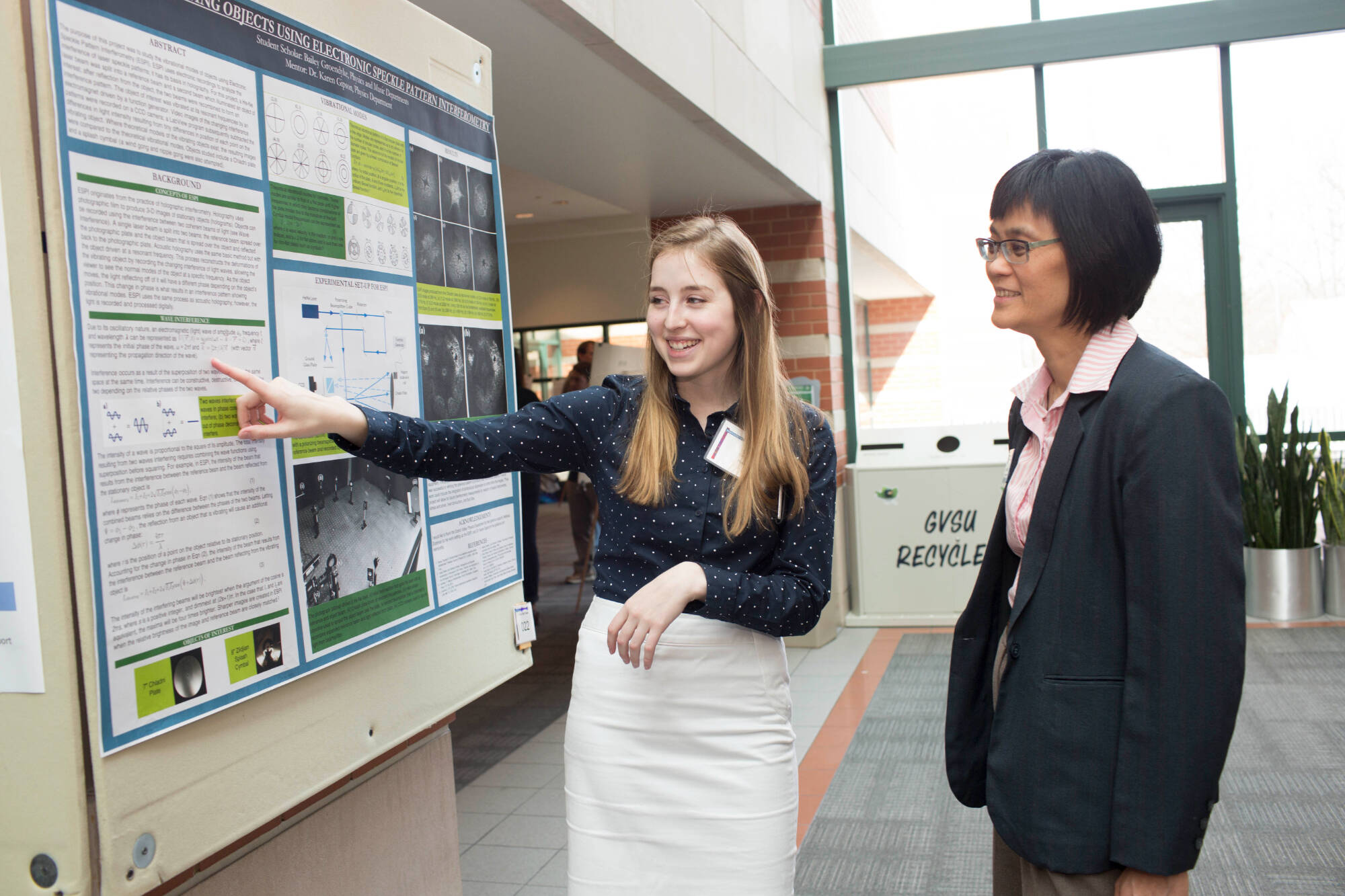 Dr. Khoo looking at student research.
